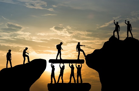 people standing on mountain or hill tops while the sunsets